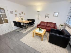 a living room with a couch and a table at Wiking, App 019 in Westerland