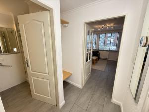 a hallway with a door leading into a room at Wiking, App 019 in Westerland