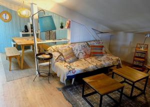 a living room with a couch and a table at 16 Bis-Gîte-Hôtel-Appartement in Marssac-sur-Tarn