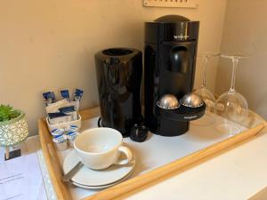 a coffee maker and a cup on a counter at Feeney's Audubon Lodge in Galway