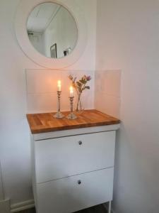 a bathroom with two candles on a counter with a mirror at Charming Bed & Breakfast - Villa Högby in Löttorp +24 photos