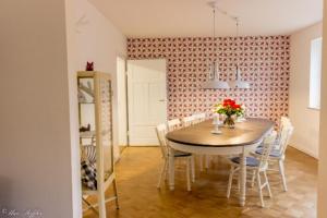 a dining room with a table and chairs at Ferienhaus Rote Sau in Herrentierbach +34 photos