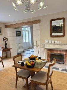 a living room with a table with a bowl of fruit at Le clos du cèdre in Cellettes