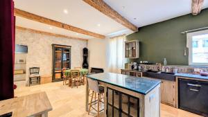 a kitchen with green walls and a counter top at Caractère de Beaumes in Beaumes-de-Venise +14 photos
