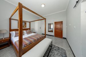 a bedroom with a canopy bed in a room at Paris Royal Estate in Lusaka