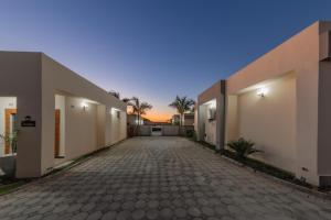 an empty courtyard of a house with a driveway at Paris Royal Estate in Lusaka