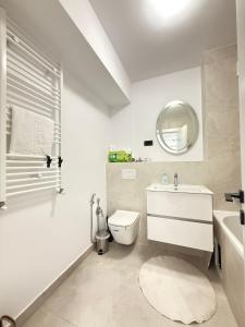 a bathroom with a sink and a toilet and a mirror at Old Town Vinyl Retreat near the Cathedral with retro vibes in Iaşi +55 photos