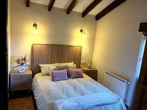 a bedroom with a bed with two pillows on it at El Refugio de Redo - balcón a los Picos de Europa in Camaleño