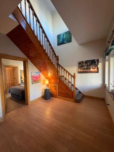 a bedroom with a staircase and a bed in a room at Feeney's Audubon Lodge in Galway