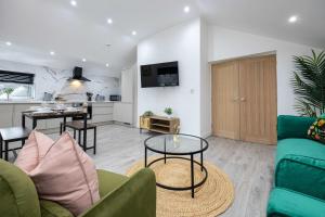 a living room with a couch and a table at The Knutsford loft in Knutsford