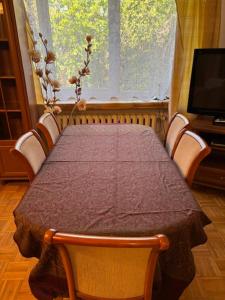 a table in a room with a table and a window at House with garden For 8 people in Suwałki