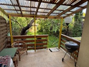 a screened in porch with a grill on a patio at House with garden For 8 people in Suwałki