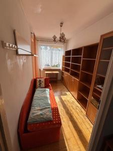 a living room with a couch and a window at House with garden For 8 people in Suwałki