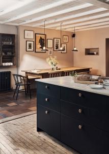 a kitchen with a large island and a table at Historic Brewery Cottage in Dorset Village Sleeps 10 in Fontmell Magna