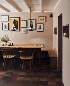 a dining room with a wooden table and chairs at Historic Brewery Cottage in Dorset Village Sleeps 10 in Fontmell Magna +51 photos