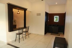 a dining room with a table and chairs in a room at Trinity Homestay Munnar in Anachal