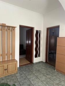 an empty room with two doors and a room with at Viktor Apartmanház in Zamárdi