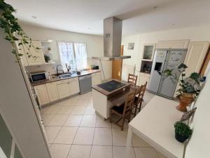 an overhead view of a kitchen with a table and chairs at La Julia Chambre meublée près de Paris in Corbeil-Essonnes +9 photos