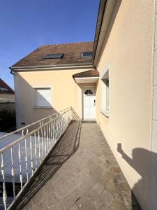 a balcony of a house with a white door at La Julia Chambre meublée près de Paris in Corbeil-Essonnes