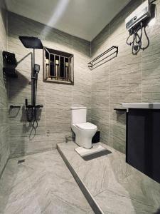 a bathroom with a toilet and a sink at Villa Casa in Accra +34 photos