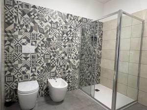 a bathroom with a toilet and a shower at Casa Vacanza Iolanda in Mafalda +4 photos