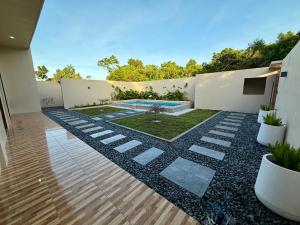 a courtyard with a swimming pool in a house at Siquijor Travellers Inn in Siquijor