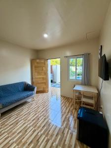 a living room with a couch and a table at Siquijor Travellers Inn in Siquijor