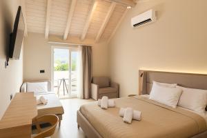 a hotel room with two beds and a chair at NOBILIS CORFU Hotel in Acharavi