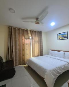 a bedroom with a bed and a ceiling fan at River View Hotel Shigar in Shigar