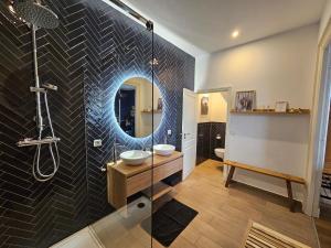 a bathroom with a sink and a mirror at B&B van Zon aan Zee in Vlissingen +65 photos