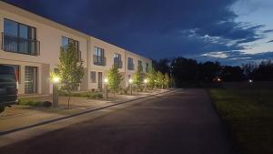 an empty street in front of a building at night at CP Residence Apart in Braşov