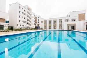 a swimming pool in front of a building at Leona Homes in Mombasa