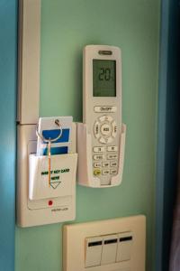 a calculator is hanging on a wall next to a box at The Nap Koh Yao Yai in Ban Nai Wat