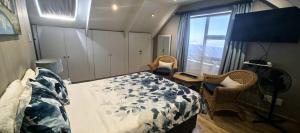 a bedroom with a bed and a table and a window at The Gables in Grotto Bay