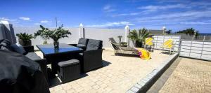 a patio with a table and chairs on a balcony at The Gables in Grotto Bay