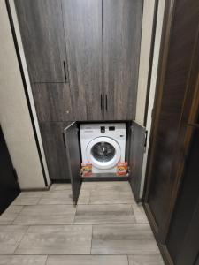 a washing machine in a cabinet in a room at Rayana's in Vanadzor
