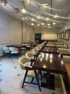 a conference room with tables and chairs and a projection screen at Hari Niwas - A Boutique Garden Resort Mount Abu in Mount Ābu