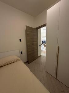 a bedroom with a bed and a door to a patio at La Dimora del Lago d'Iseo in Sarnico