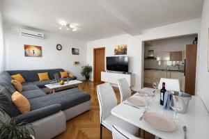 a living room with a couch and a table at Diocles Place in Split