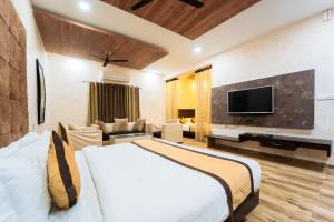 a hotel room with a bed and a tv at Thar Exotica Hotel & Resort Bikaner in Bikaner