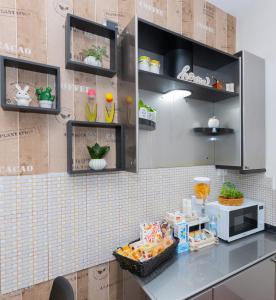 a kitchen with a counter with a microwave at Dimora Nicotera in Lamezia Terme +26 photos