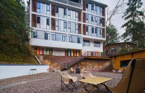 a table and chairs in front of a building at Astria Moruo Retreat in Xinglong