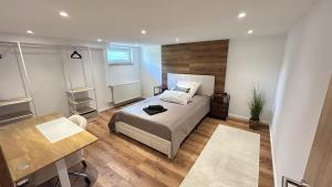 a bedroom with a bed and a table and a desk at Ferienwohnung Nella in Paderborn