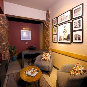 a living room with a couch and chairs and a table at Esin Hotel in Denizli