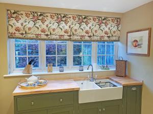 a kitchen with a sink and a window at Freshwater Barn in Benenden