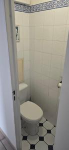 a bathroom with a white toilet and a black and white floor at Marseille Estaque in Marseille +8 photos