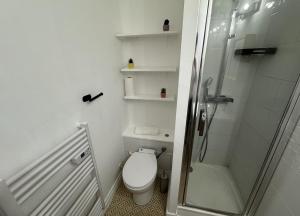a white bathroom with a toilet and a shower at T2 Hyper centre Senlis in Senlis