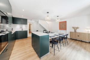 a kitchen with a table and chairs in a room at Belle maison 8 personnes à 600m de la plage avec parking privé in Dinard +20 photos