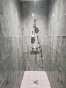 a bathroom with a shower with a toilet in it at Belle maison 8 personnes à 600m de la plage avec parking privé in Dinard