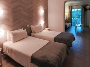 a hotel room with two beds and a mirror at Villa Welwitshia in Carvoeiro +48 photos